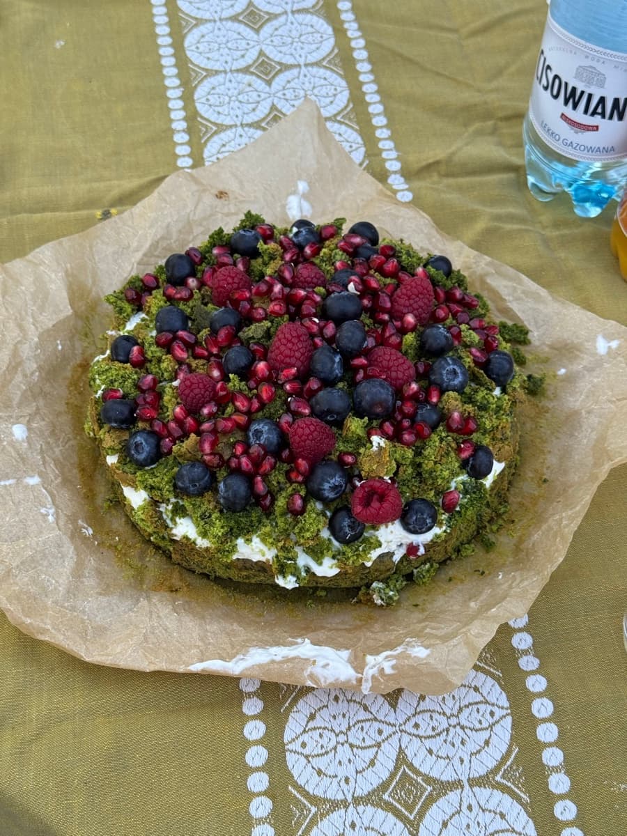 Polish forest moss cake with berries and pomegranate